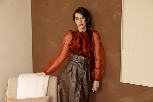 Burnt orange blouse with puff sleeves and tie neck